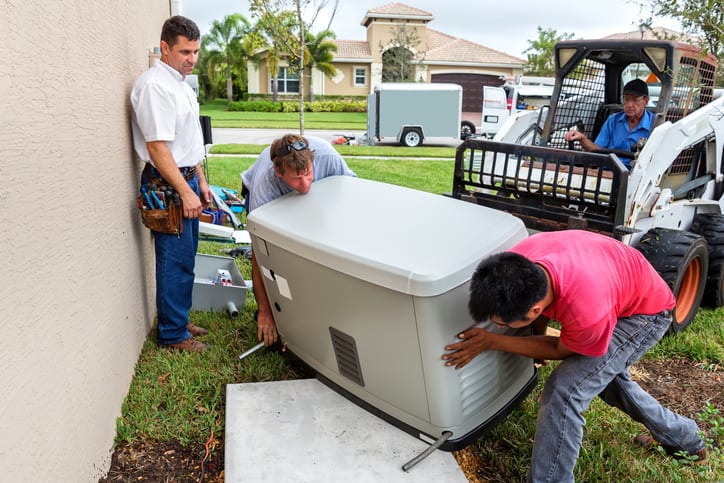 E.E.S. Inc. | employees installing a generator outside of a residential home